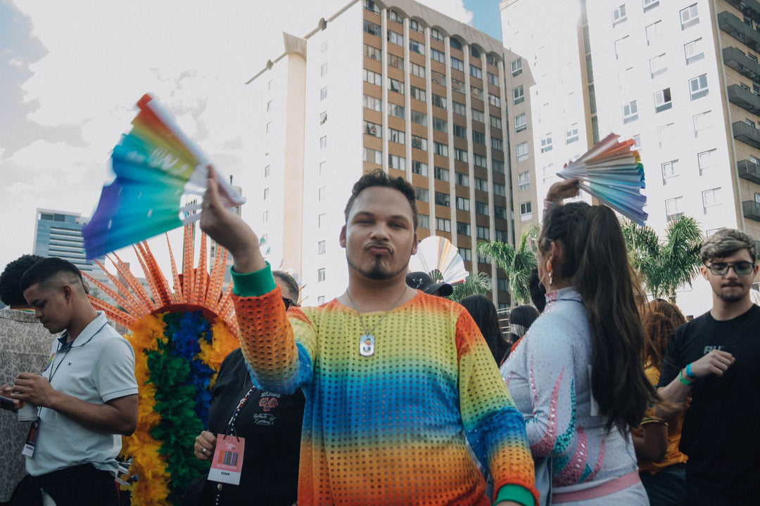 People in colorful pride outfits at a Pride parade — what to wear to Pride as an ally