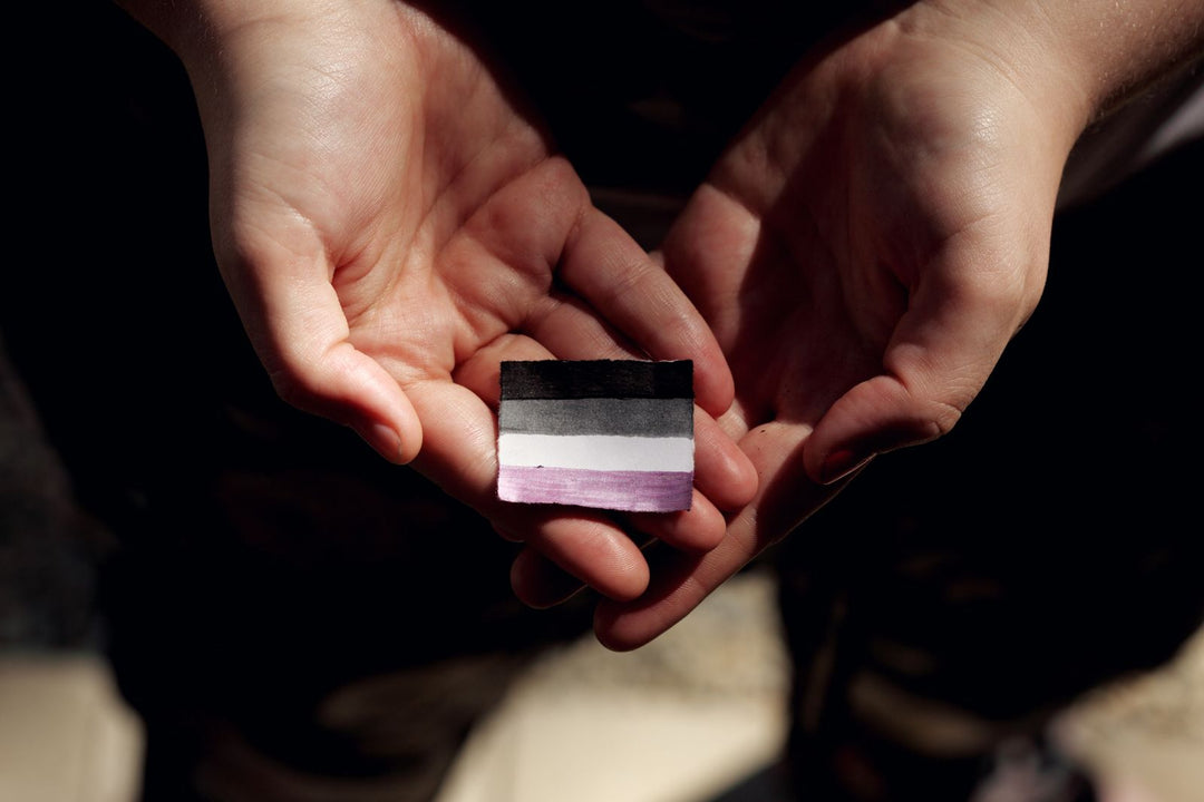 Demisexual meaning — hands gently holding an ace-spectrum pride flag