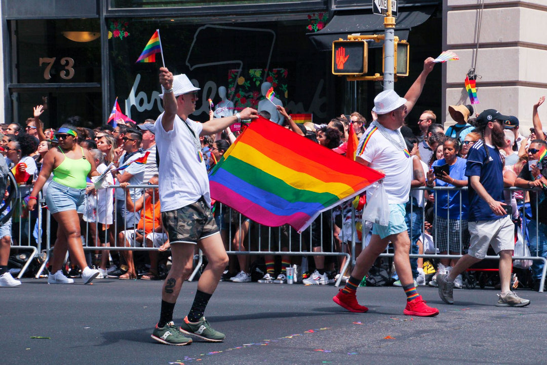 Pride gift guide — marchers celebrating with a rainbow pride flag